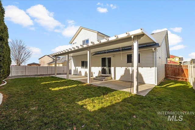 rear view of house featuring a patio area and a lawn