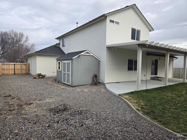 back of property featuring a storage unit and a patio area