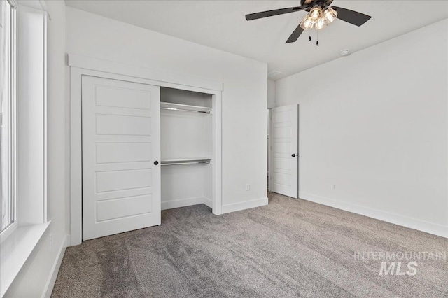 unfurnished bedroom with a closet, carpet flooring, and baseboards