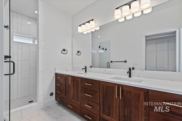 bathroom with a stall shower, tile patterned floors, a sink, and double vanity