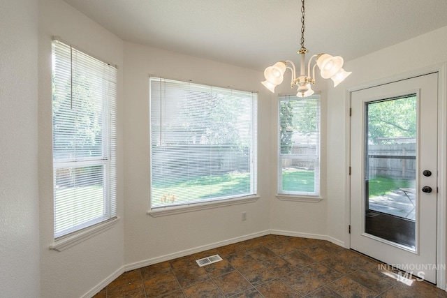 5426 W Samara Ct, Boise, ID 83703 - unfurnished dining area with a chandelier and baseboards