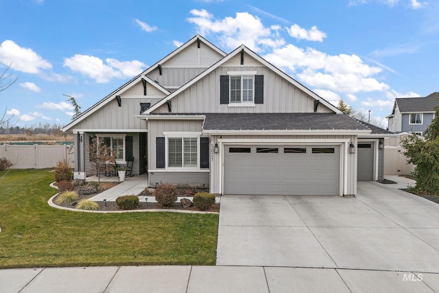 craftsman-style house with covered porch, a front yard, and a garage