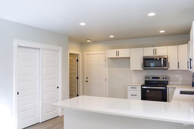 602 E Freeport St, Caldwell, ID 83605 - kitchen featuring stainless steel appliances, a sink, a peninsula, white cabinets, and light countertops