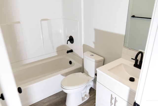 602 E Freeport St, Caldwell, ID 83605 - bathroom with toilet, shower / bathtub combination, vanity, and wood finished floors