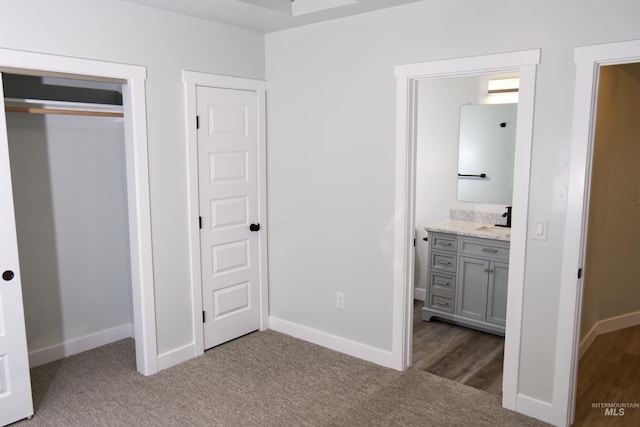 602 E Freeport St, Caldwell, ID 83605 - unfurnished bedroom with a sink, carpet, baseboards, ensuite bathroom, and a closet