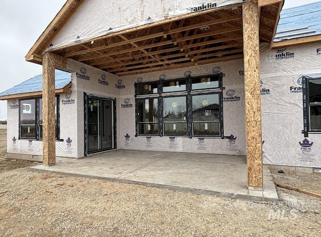 rear view of house with crawl space and stucco siding