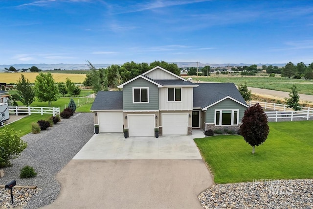 27482 Warren Ln, Wilder, ID 83676 - view of front of house featuring concrete driveway, an attached garage, board and batten siding, stone siding, and a view of countryside