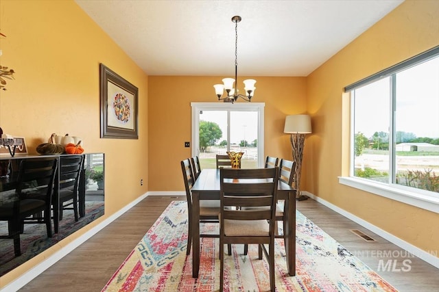 27482 Warren Ln, Wilder, ID 83676 - dining space with a chandelier and wood finished floors