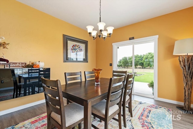 27482 Warren Ln, Wilder, ID 83676 - dining space featuring wood finished floors and a chandelier
