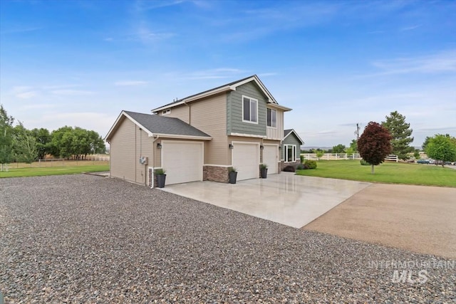 27482 Warren Ln, Wilder, ID 83676 - view of home's exterior featuring concrete driveway, a lawn, and an attached garage