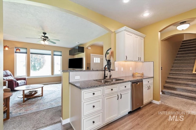 27482 Warren Ln, Wilder, ID 83676 - kitchen featuring stainless steel dishwasher, dark stone countertops, open floor plan, ceiling fan, and recessed lighting