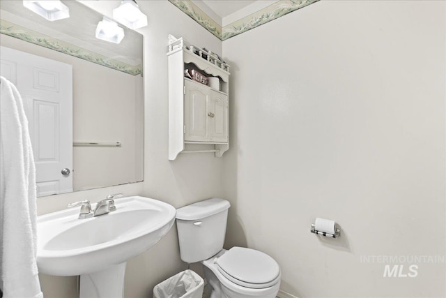 bathroom featuring toilet and a sink