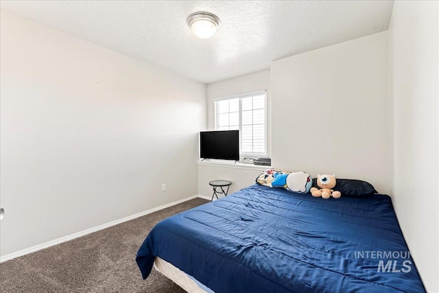 bedroom featuring carpet flooring, a textured ceiling, and baseboards