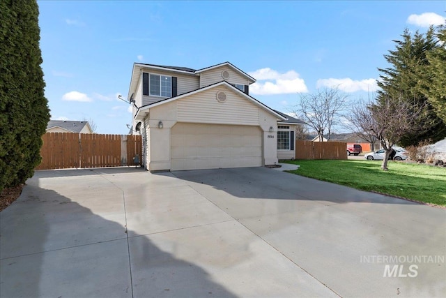 view of front facade featuring a front yard, fence, a garage, and driveway