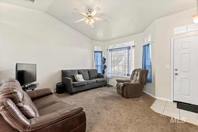 living room featuring lofted ceiling, carpet, baseboards, and ceiling fan