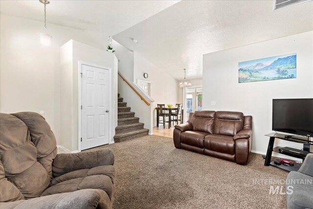 living room with visible vents, stairway, carpet, baseboards, and vaulted ceiling