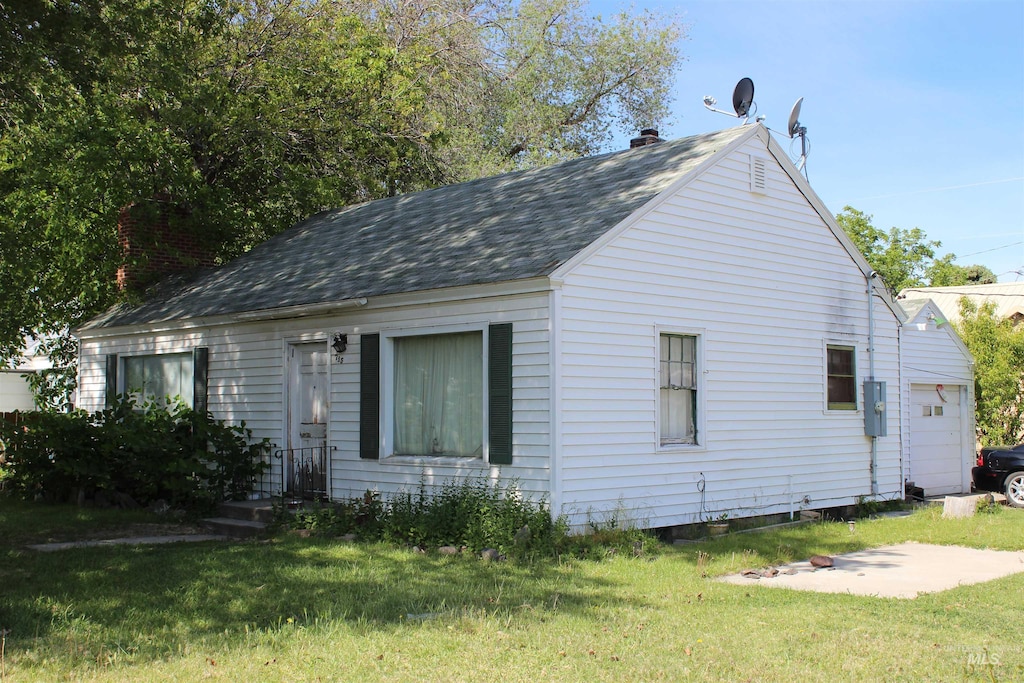 exterior space with a garage and a yard