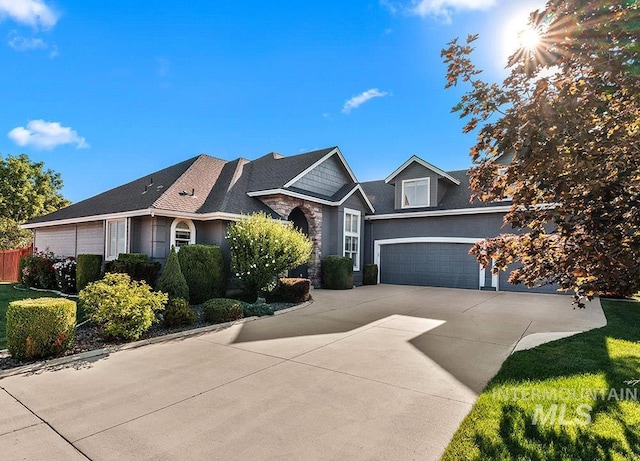 1730 W Glade Creek St, Meridian, ID 83646 - view of front of property with driveway, stone siding, and a garage