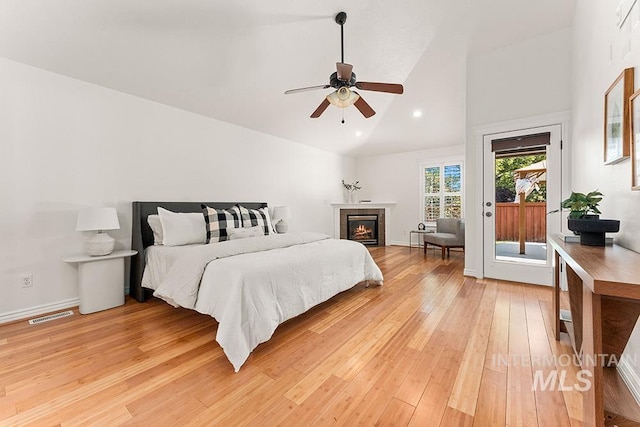 1730 W Glade Creek St, Meridian, ID 83646 - bedroom featuring access to exterior, light wood-style floors, high vaulted ceiling, a tile fireplace, and a ceiling fan