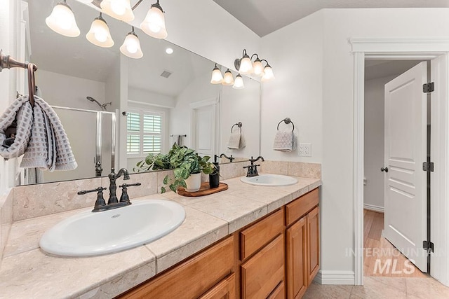 1730 W Glade Creek St, Meridian, ID 83646 - bathroom featuring a shower stall, double vanity, a chandelier, and tile patterned floors