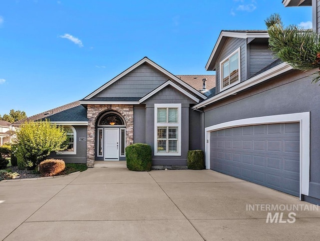 1730 W Glade Creek St, Meridian, ID 83646 - view of front facade with driveway, stone siding, and a garage