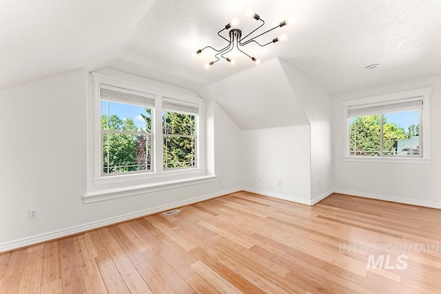 1730 W Glade Creek St, Meridian, ID 83646 - additional living space featuring healthy amount of natural light, wood finished floors, and vaulted ceiling