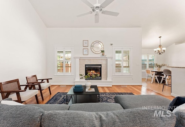 1730 W Glade Creek St, Meridian, ID 83646 - living area with light wood-type flooring, a chandelier, a fireplace, and ceiling fan