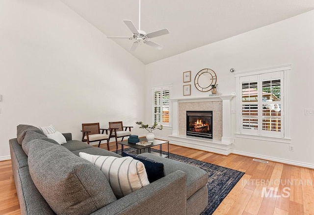 1730 W Glade Creek St, Meridian, ID 83646 - living room with hardwood / wood-style flooring, high vaulted ceiling, a ceiling fan, and a tile fireplace