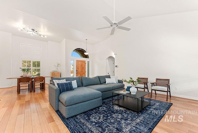 1730 W Glade Creek St, Meridian, ID 83646 - living area with light wood-style flooring, arched walkways, a ceiling fan, and vaulted ceiling