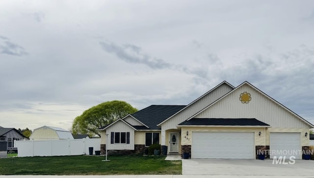 view of front of house featuring an attached garage, concrete driveway, and a shingled roof