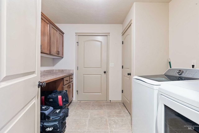 laundry area with washing machine and dryer and cabinet space