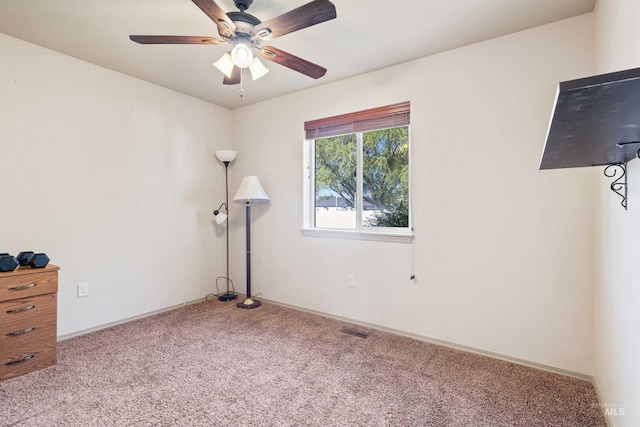 unfurnished bedroom with carpet floors, baseboards, and a ceiling fan