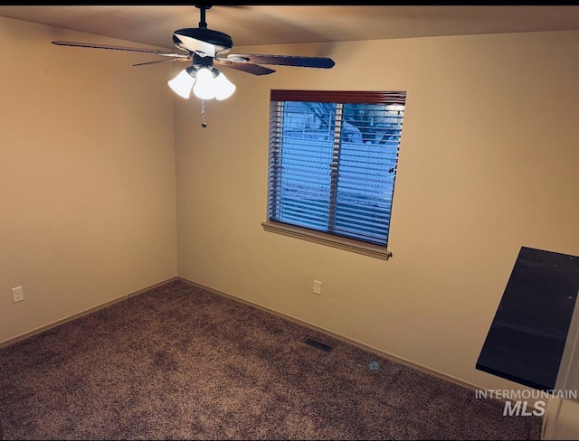 spare room featuring carpet flooring, a ceiling fan, and baseboards