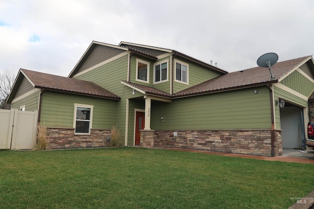 view of front of home with a front yard and a garage