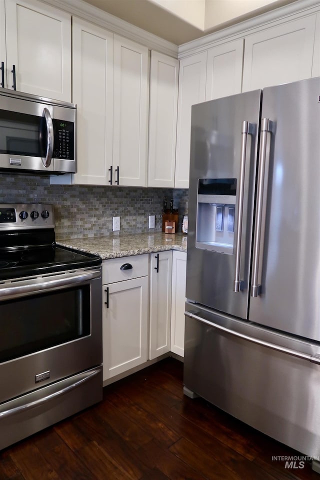 kitchen featuring white cabinets, stainless steel appliances, and dark hardwood / wood-style floors