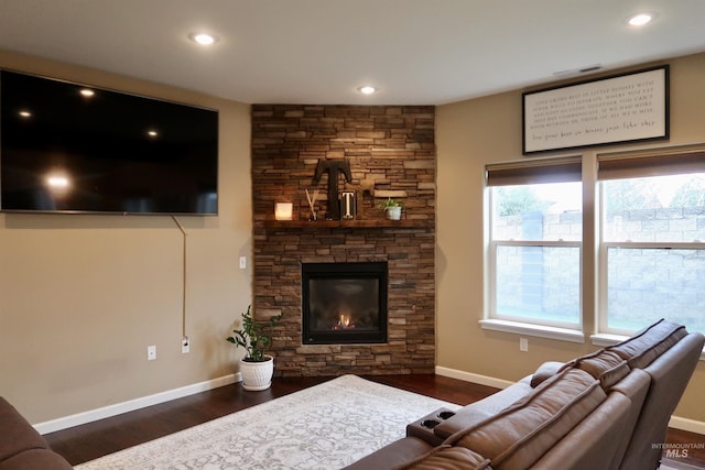 living room featuring a fireplace and dark hardwood / wood-style floors