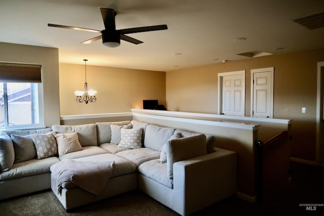 living room with ceiling fan with notable chandelier