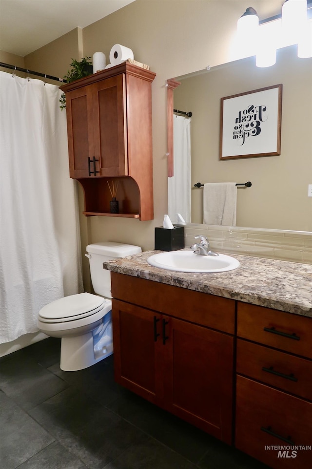 bathroom featuring tile patterned flooring, vanity, and toilet