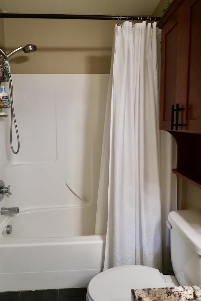 bathroom with tile patterned floors and shower / tub combo