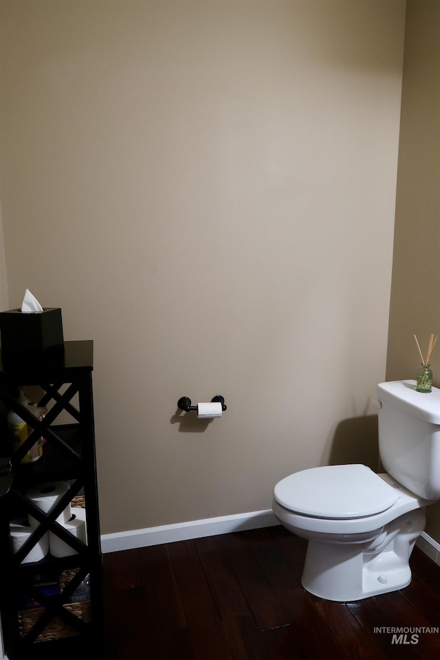 bathroom featuring toilet and wood-type flooring