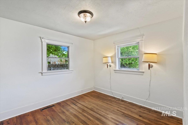 519 S 5th Ave, Nampa, ID 83651 - unfurnished room with dark wood-style flooring and a textured ceiling