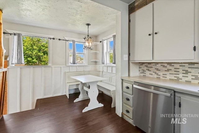 519 S 5th Ave, Nampa, ID 83651 - dining space featuring plenty of natural light, dark wood-type flooring, a textured ceiling, a chandelier, and wainscoting
