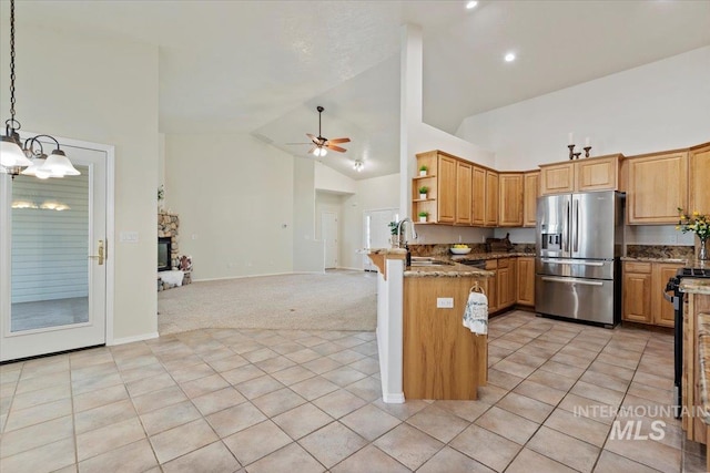 kitchen featuring light colored carpet, stainless steel appliances, open shelves, a sink, and ceiling fan with notable chandelier