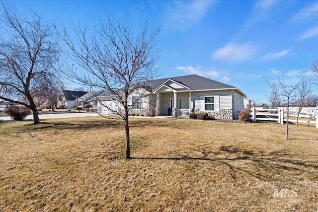 ranch-style house with a porch, a front yard, and fence