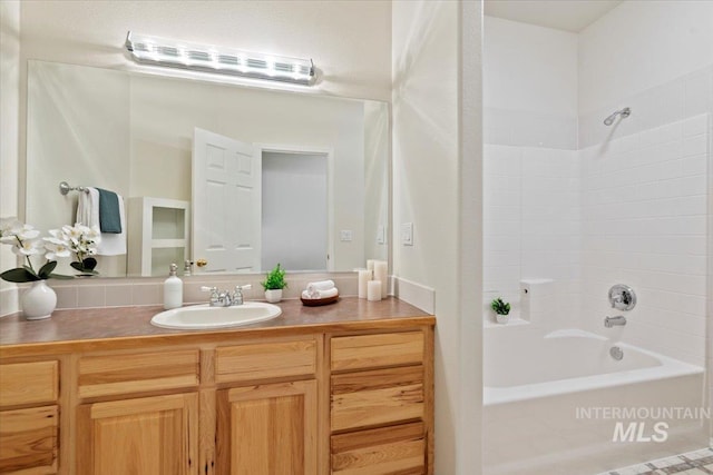 bathroom with shower / bathing tub combination and vanity