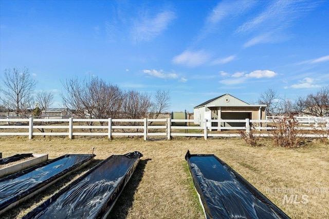 view of yard with an exterior structure, a rural view, and an outdoor structure