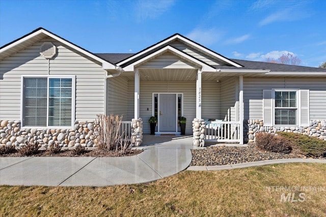 ranch-style house with a porch and a front yard