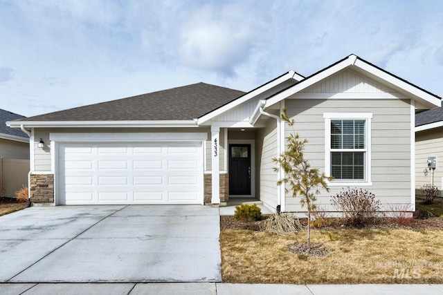 single story home featuring a garage, concrete driveway, a shingled roof, and stone siding