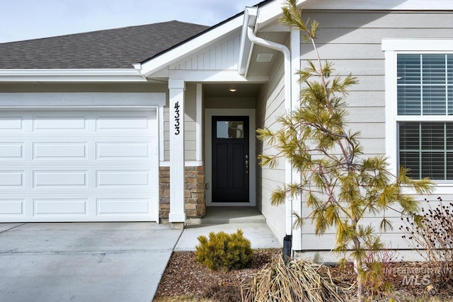 property entrance featuring a garage and roof with shingles