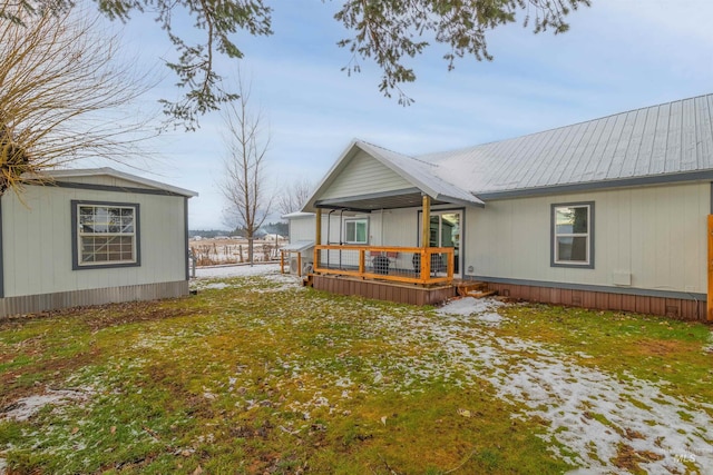 back of property with covered porch